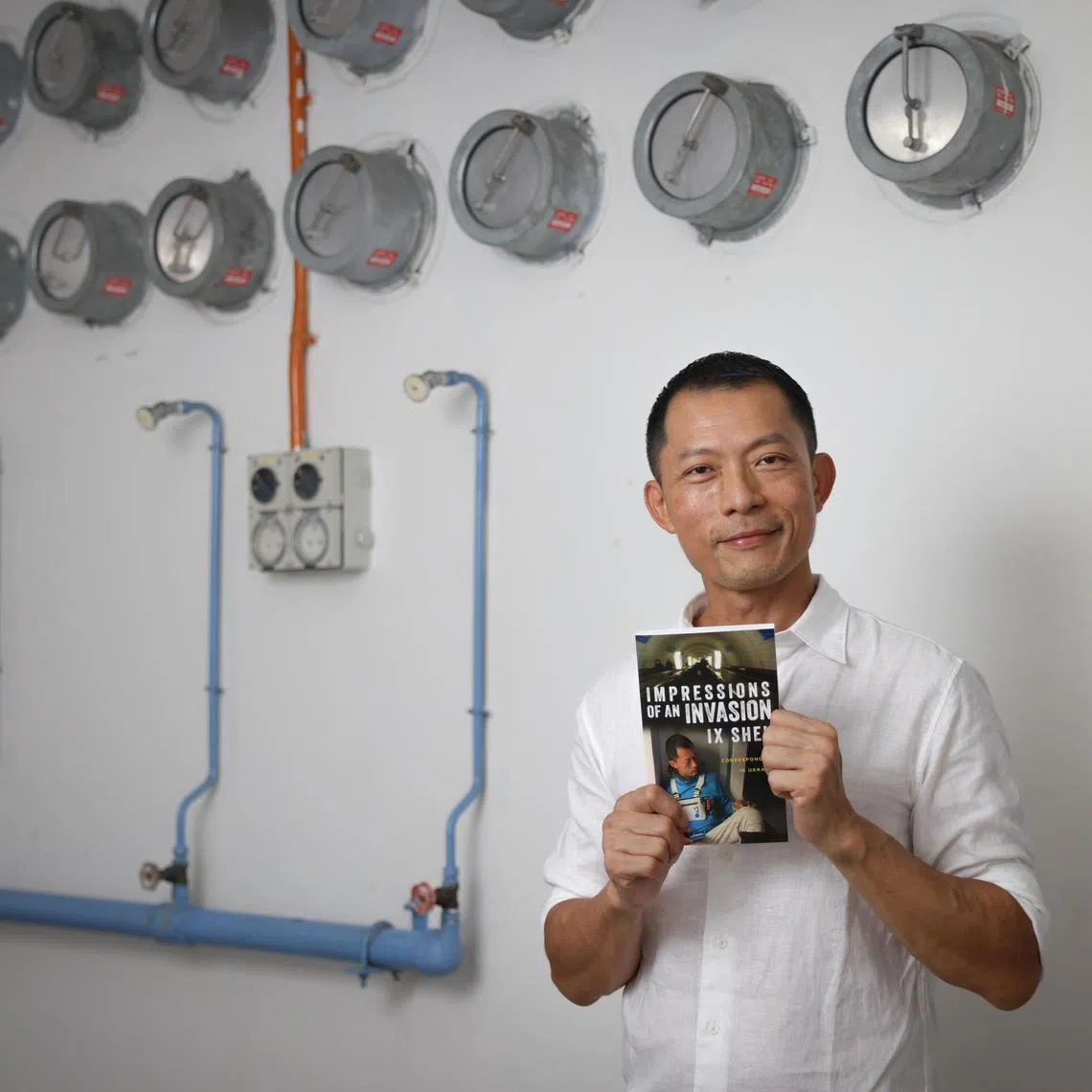 aeinvasion25 ST20230525_202374944060 Ong Wee Jin / Alexandria Ee  /

Ix Shen unveils his autobiography, "Impressions of an Invasion: A Correspondent in Ukraine" within the confines of a secret bunker.

Photographed on May 25, 2023.