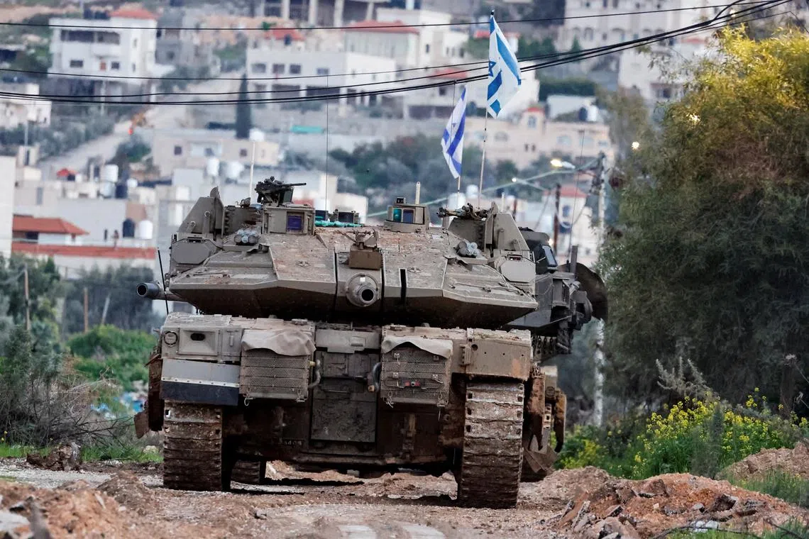 An Israeli tank operates in Jenin, February 23, 2025. REUTERS/Raneen Sawafta