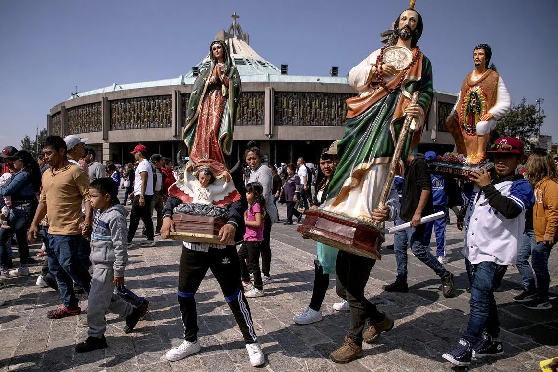 Pilgrimage parishioners carry statues as they arrive to celebrate the day of the Virgin of Guadalupe at the Basilica of Guadalupe, in Mexico City, Mexico, Dec 11, 2022. 