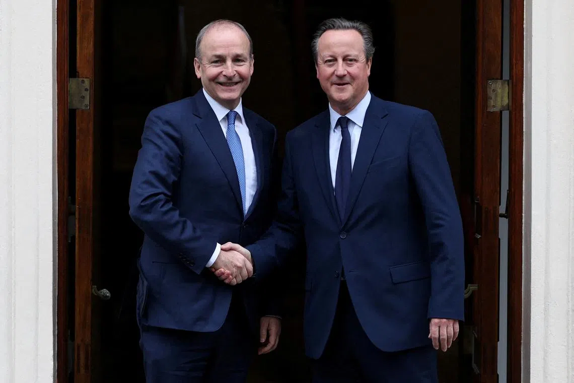 FILE PHOTO: Britain's Foreign Secretary David Cameron greets Ireland's Deputy Prime Minister and Foreign Minister Micheal Martin at Carlton Gardens, in central London, Britain December 13, 2023.     ADRIAN DENNIS/Pool via REUTERS/File Photo
