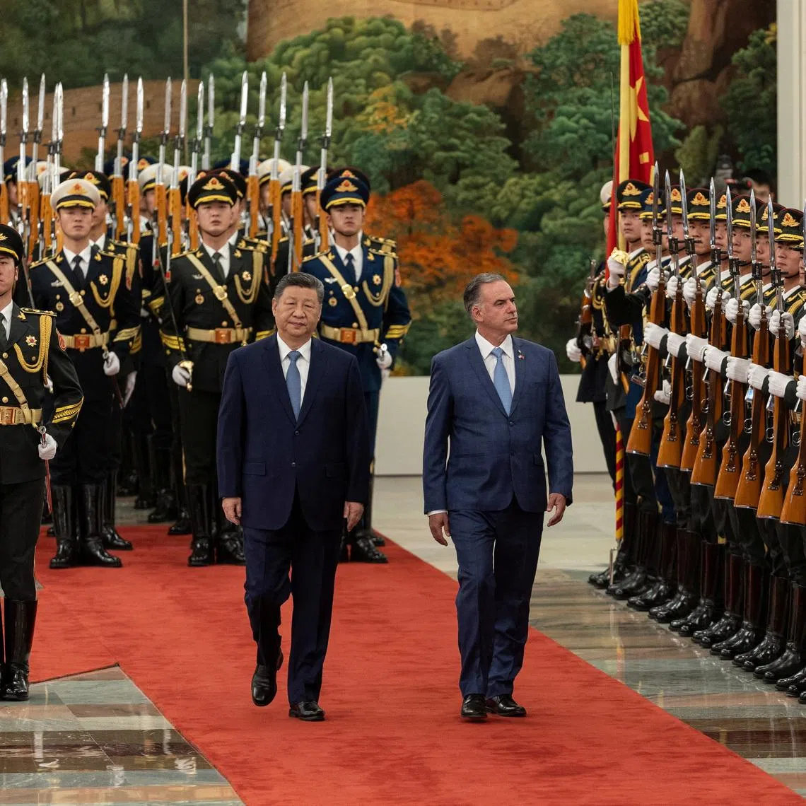 Uruguayan President Yamandu Orsi walks with Chinese President Xi Jinping in Beijing, on Feb 3.
