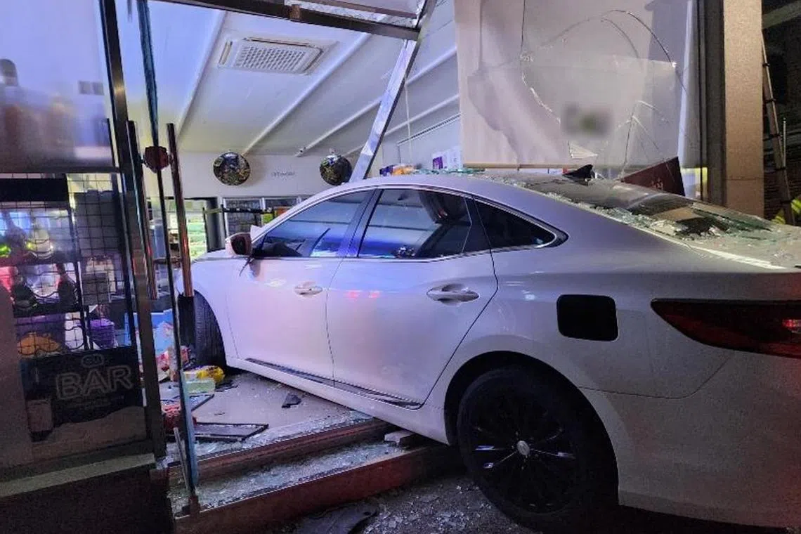 The driver slammed the car into the store in Geoje city, then rushed in and assaulted the owner.