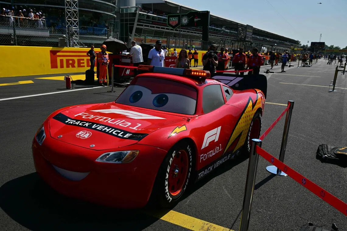 A life-sized custom-built replica of Disney Pixar’s Lightning McQueen character from "Cars" movie is displayed in the pit lane ahead the Italian Formula One Grand Prix at the Autodromo Nazionale Monza circuit in Monza, northern Italy on September 6, 2026. (Photo by Andrej ISAKOVIC / AFP)