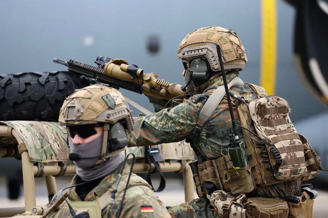 FILE PHOTO: A member of Air Mobile Protection Team sits on a vehicle as German Chancellor Olaf Scholz visits the Cologne-Bonn Air Force base to attend a demonstration of the capabilities of the Territorial Command of the German army Bundeswehr in Wahn, a suburb of Cologne, Germany, October 23, 2023.  REUTERS/Wolfgang Rattay/File Photo