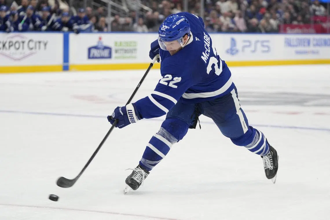 FILE PHOTO: Oct 24, 2024; Toronto, Ontario, CAN; Toronto Maple Leafs defenseman Jake McCabe (22) shoots the puck against the St. Louis Blues during the third period at Scotiabank Arena. Mandatory Credit: John E. Sokolowski-Imagn Images/File Photo