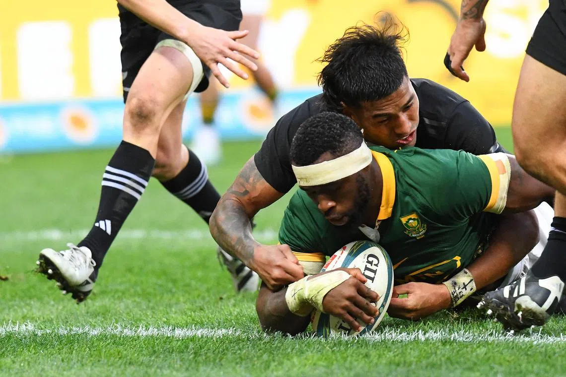 South Africa's flanker Siya Kolisi (centre) scores a try during the Rugby Championship Test match between South Africa and New Zealand, in Cape Town on Sept 7.