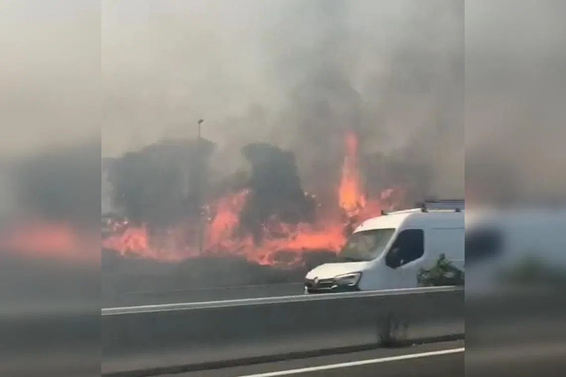 Road and rail traffic was interrupted by the blaze, which affected an uninhabited area close to a highway.