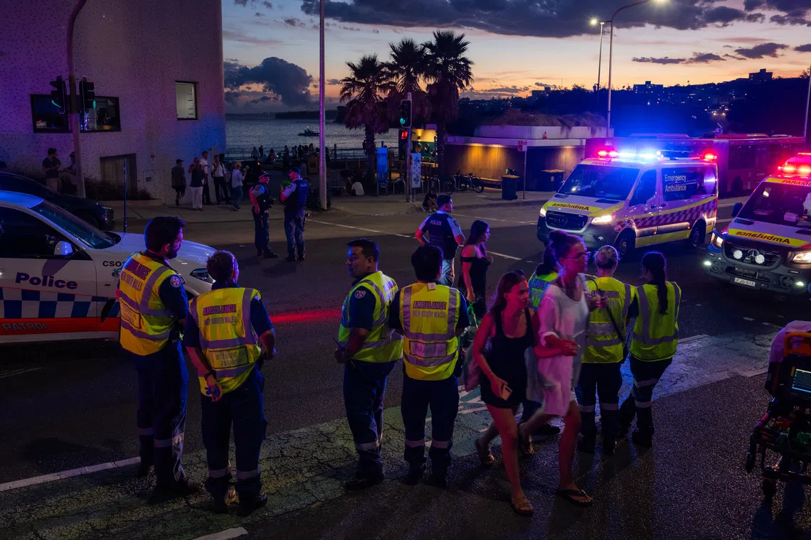Police and paramedics at the site of a shooting at Bondi Beach in Sydney on Dec 14.