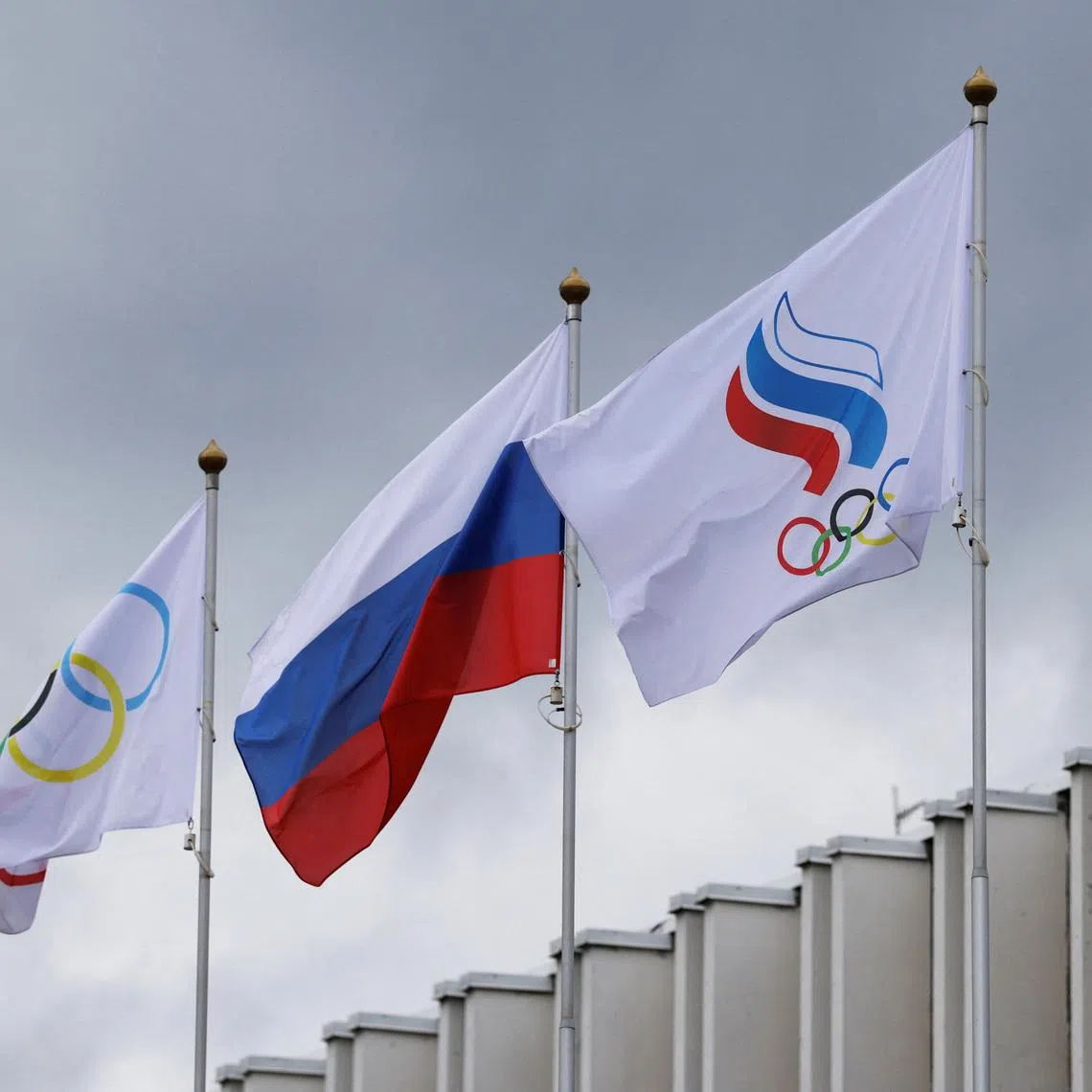 The Russian flag, the Olympic flag and the flag of the Russian Olympic Committee fly at the Committee's headquarters in Moscow, Russia July 8, 2026. REUTERS/Ramil Sitdikov