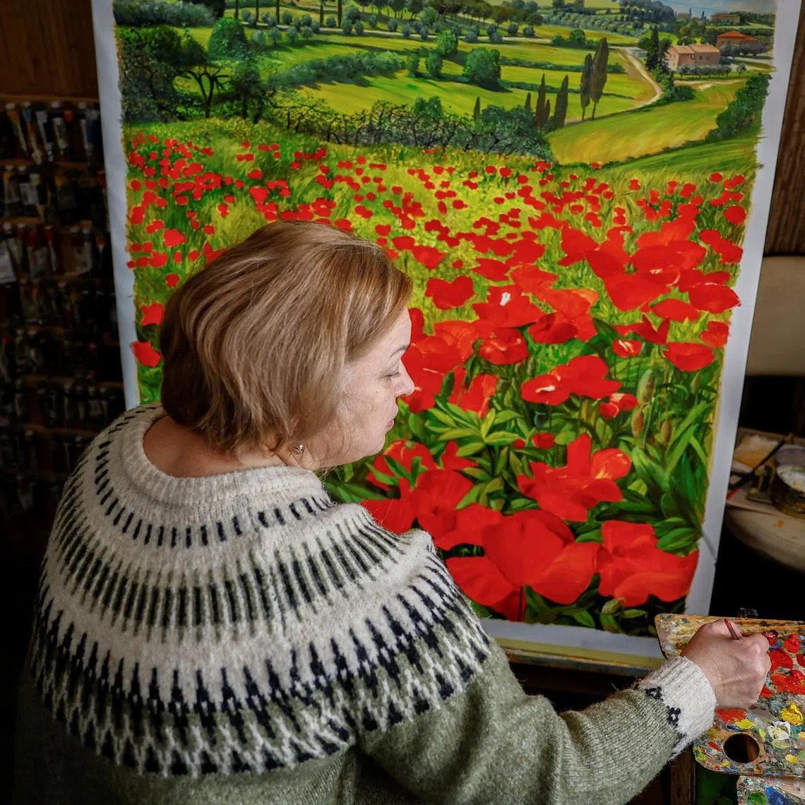 Iryna Prots, 52, artist who designed the Ukrainian skeleton racer Vladyslav Heraskevych helmet, which he wears as a tribute to athletes who were killed amid Russia's attack on Ukraine, works in her appartment in Kyiv, Ukraine, February 11, 2026. REUTERS/Alina Smutko