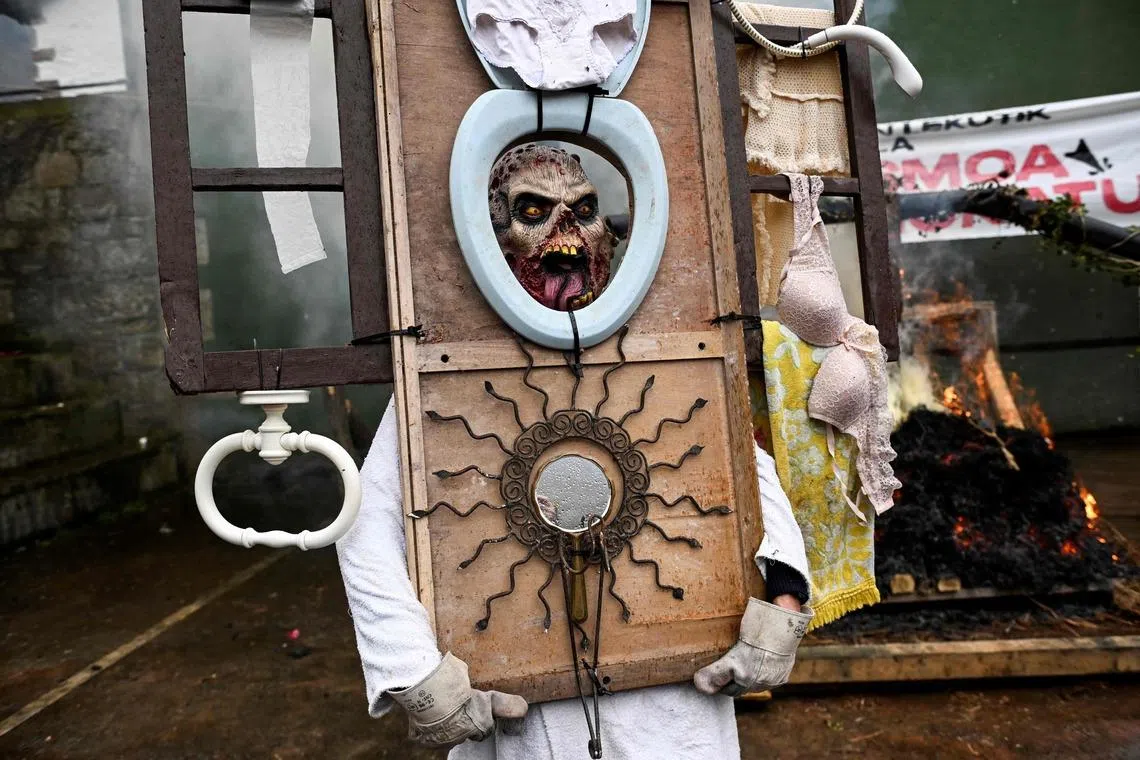 A masked reveller taking part in the traditional carnival of Ituren in the northern Spanish province of Navarre on Jan 26, 2026. Locals from the neighbouring villages of Ituren and Zubieta dress up and participate in a pilgrimage through both villages in this annual three-day festival, revolving mainly around agriculture and sheep herding. 