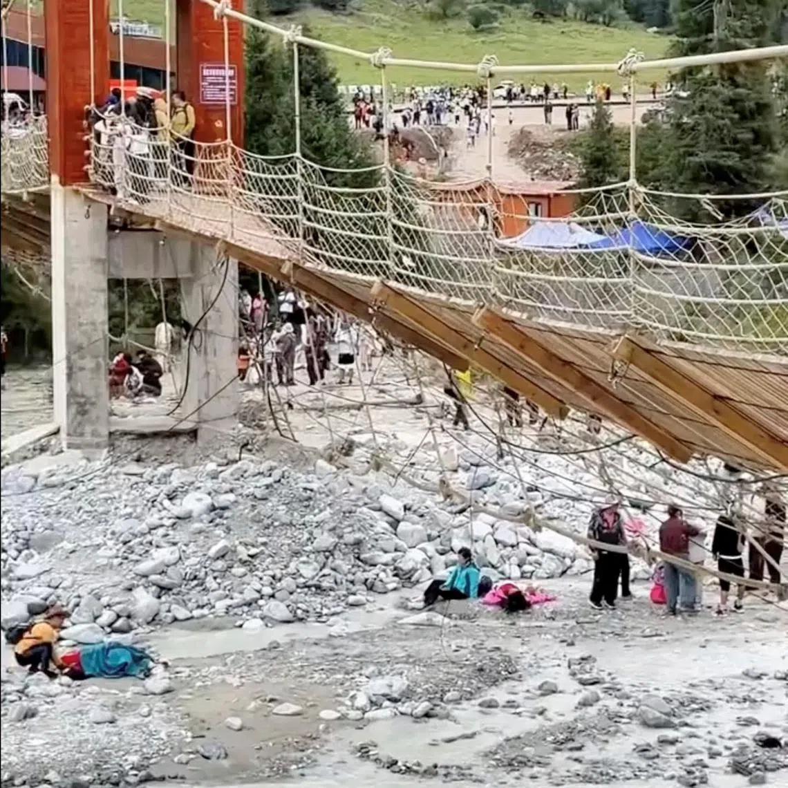 Aftermath of a suspension bridge collapse in Yili, Xinjiang Uyghur Autonomous Region, China in this screen grab obtained from a social media video on date given as August 6, 2025. Social Media/via REUTERS