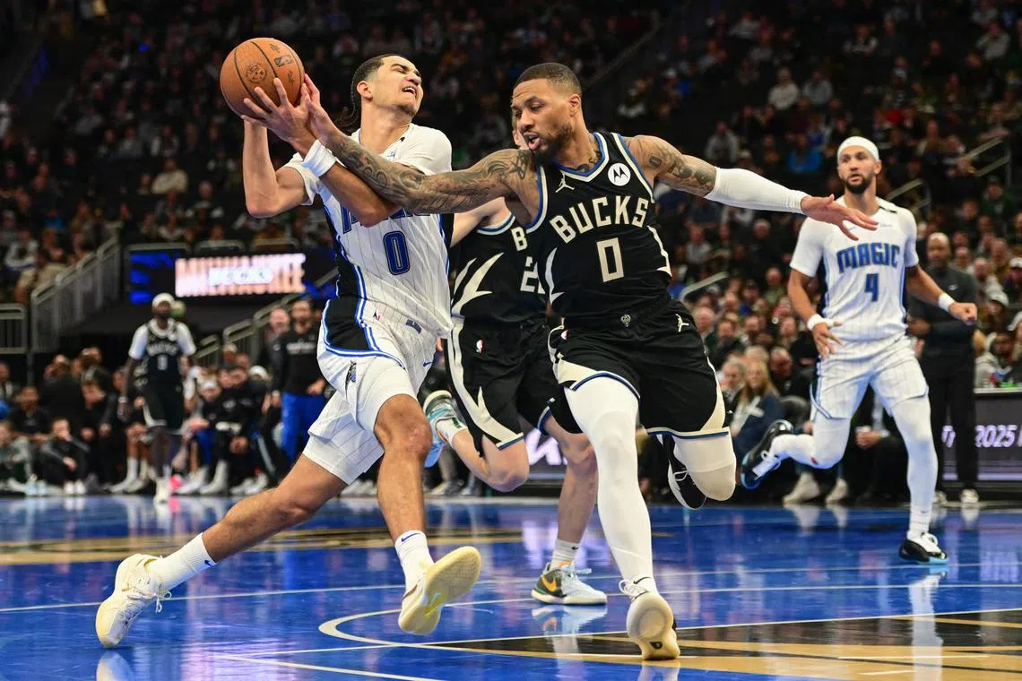 Orlando Magic guard Anthony Black drives for the basket against Milwaukee Bucks guard Damian Lillard in the fourth quarter at Fiserv Forum.