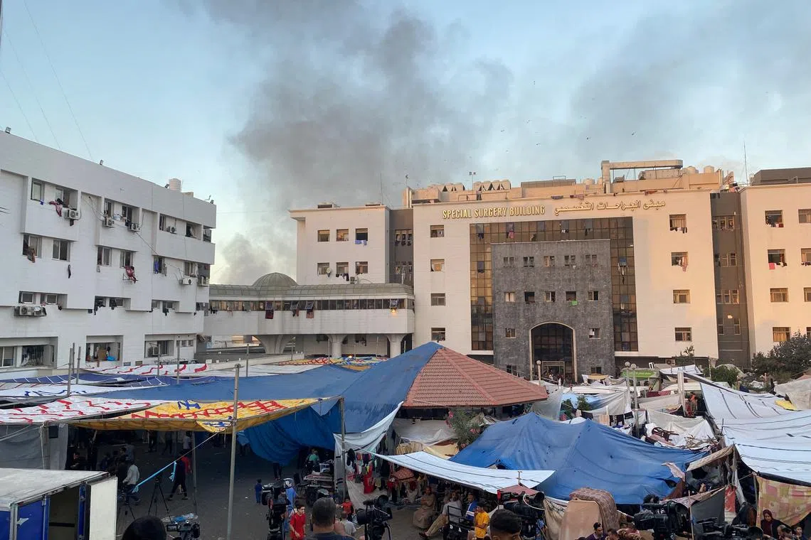 FILE PHOTO: Smoke rises as displaced Palestinians take shelter at Al Shifa hospital, amid the ongoing conflict between Hamas and Israel, in Gaza City, November 8, 2023. REUTERS/Doaa Rouqa/File Photo