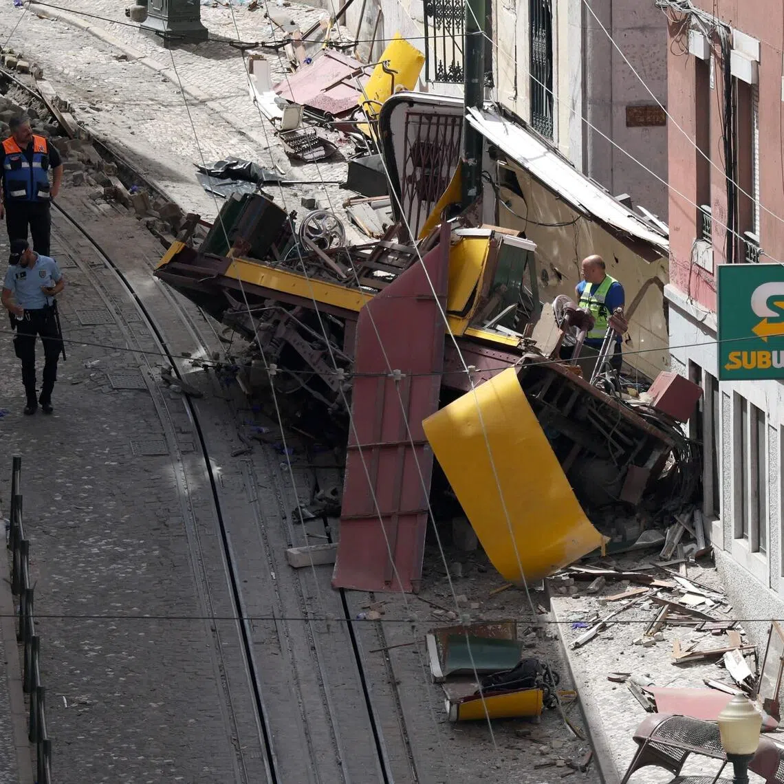 Police and civil protection members work on the site of the Gloria funicular accident that killed 16 a day earlier in Lisbon, on September 4, 2025. 