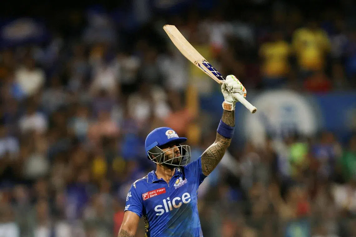 Mumbai Indians' Suryakumar Yadav raising his bat after scoring a half century against Royal Challengers Bangalore in an Indian Premier League cricket match in May.