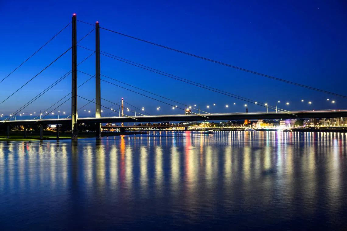 FILE PHOTO: A general view shows the river Rhine with the Rheinkniebruecke in the background in Duesseldorf, Germany, May 13, 2024. Picture taken with long exposure. REUTERS/Jana Rodenbusch/File Photo