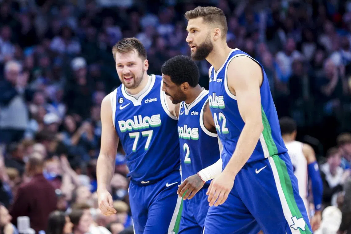 Dallas Mavericks guard Luka Doncic (No. 77) and teammates Kyrie Irving (No. 2) and Maxi Kleber celebrating during the game Philadelphia 76ers.