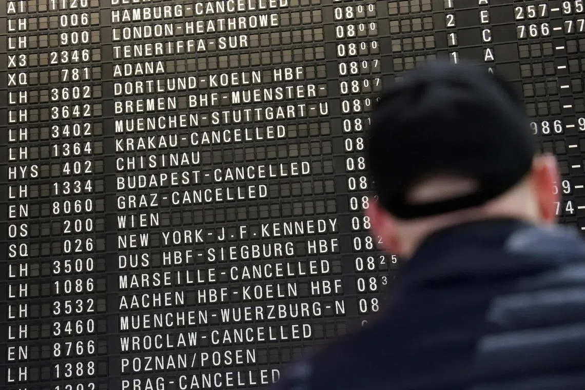 A traveller looks at an information board on the day of a strike by Lufthansa ground staff in Frankfurt, Germany, February 7, 2024.     REUTERS/Maximilian Schwarz/File Photo