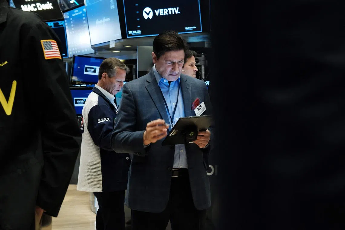 Traders work on the floor of the New York Stock Exchange, in New York City.