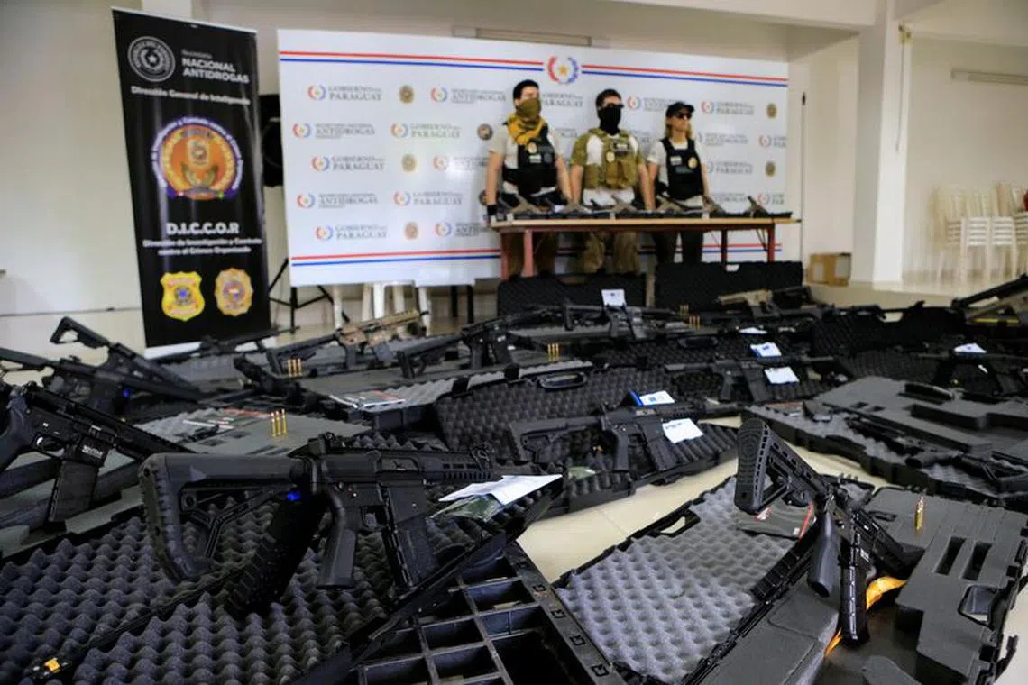 Paraguay's National Anti-Drug Secretariat (SENAD) officers display weapons sent from Europe to be sold to Brazil's largest criminal groups, seized during dozens of raids across Paraguay and Brazil, in Asuncion, Paraguay, December 6, 2023. REUTERS/Cesar Olmedo