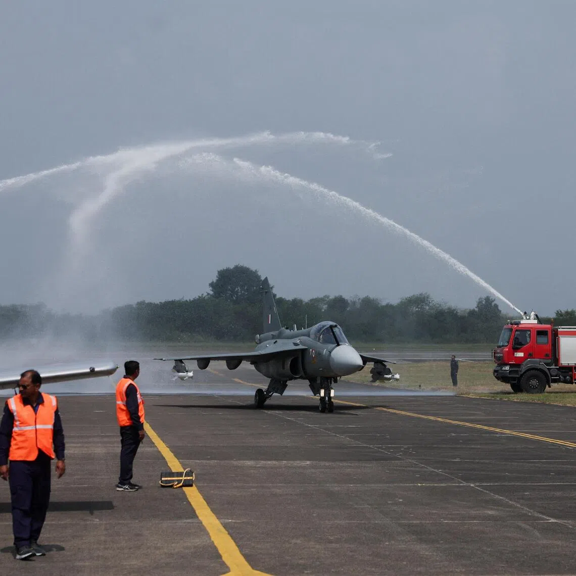 The Tejas Mk1A receiving a water-cannon salute after its maiden flight in Nashik, India, on Oct 17.