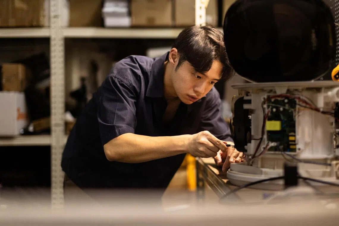 Prism+ product manager Jonathan Loh working on a mini-washer prototype at the company’s test labs.