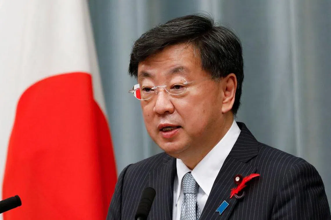 FILE PHOTO: Japan's new Chief of Cabinet Secretary Matsuno Hirokazu announces new cabinet members at a news conference in Tokyo, Japan October 4, 2021. REUTERS/Kim Kyung-Hoon/File Photo