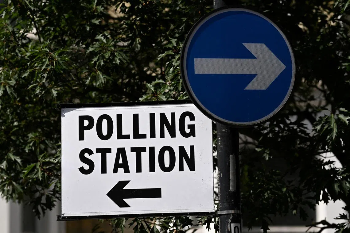 FILE PHOTO: A polling station sign is seen at a road junction during the general election, in London, Britain, July 4, 2024. REUTERS/Dylan Martinez/File Photo