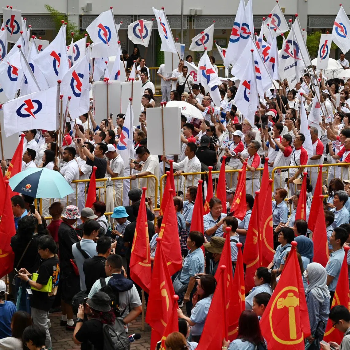 PAP and WP supporters swarmed the parade square at Poi Ching School after a light shower.
