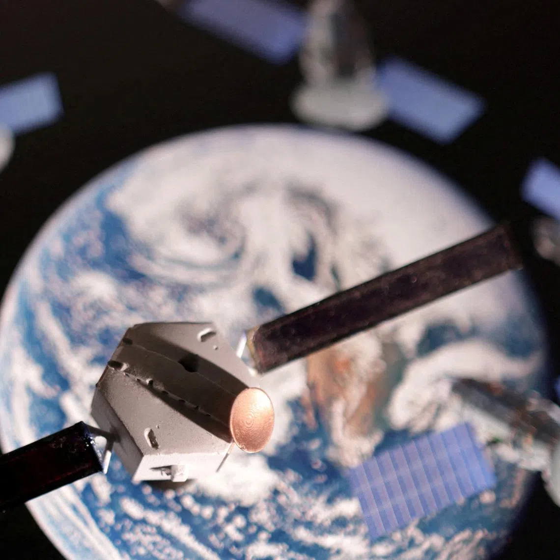 FILE PHOTO: A satellite model is placed on a picture of Earth in this illustration taken November 25, 2024. REUTERS/Dado Ruvic/Illustration/File Photo