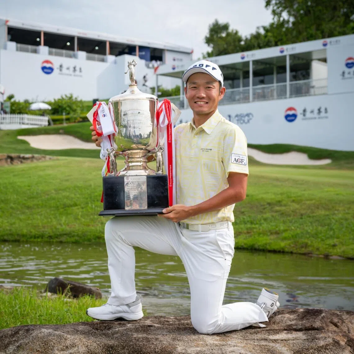Japanese golfer Yosuke Asaji posing with his trophy at the Moutai Singapore Open 2025.