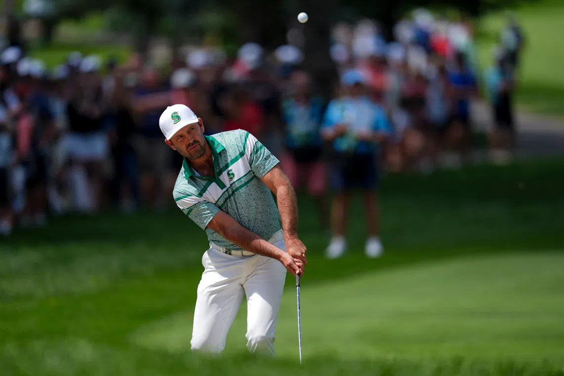 Aug 24, 2025; Detroit, Michigan, USA; Charl Schwartzel of Stinger GC chips onto the first green during the finals of the LIV Golf Michigan Team Championship at The Cardinal at Saint John's Resort. Mandatory Credit: Aaron Doster-Imagn Images
