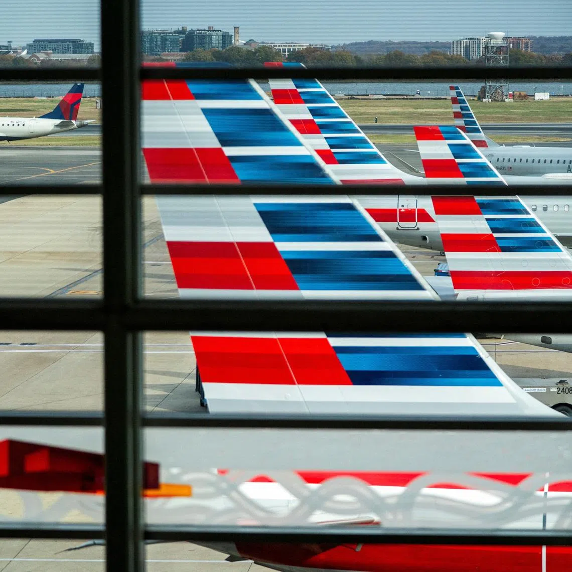 American Airlines flights stage at Ronald Reagan Washington National Airport as the Trump administration warns of impending cuts to commercial airline operations more than a month into the continuing U.S. government shutdown in Arlington, Virginia, U.S., November 7, 2025. REUTERS/Nathan Howard