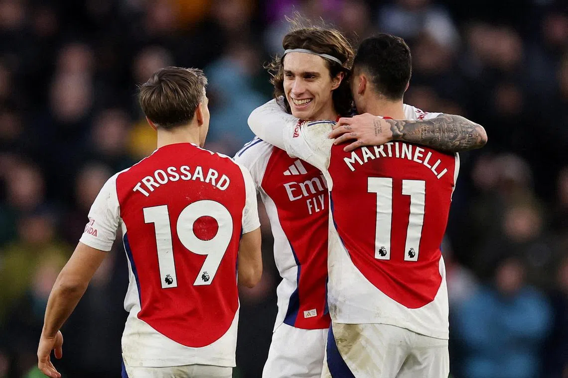 Arsenal's Riccardo Calafiori celebrates scoring what proved to be the only goal of the match with teammates Gabriel Martinelli and Leandro Trossard.