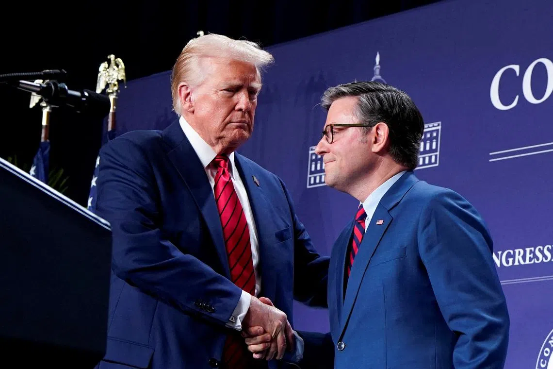 FILE PHOTO: U.S. President Donald Trump and Speaker of the House Mike Johnson shake hands during a House Republican members conference meeting in Trump National Doral resort, in Miami, Florida, U.S. January 27, 2025.  REUTERS/Elizabeth Frantz/File Photo