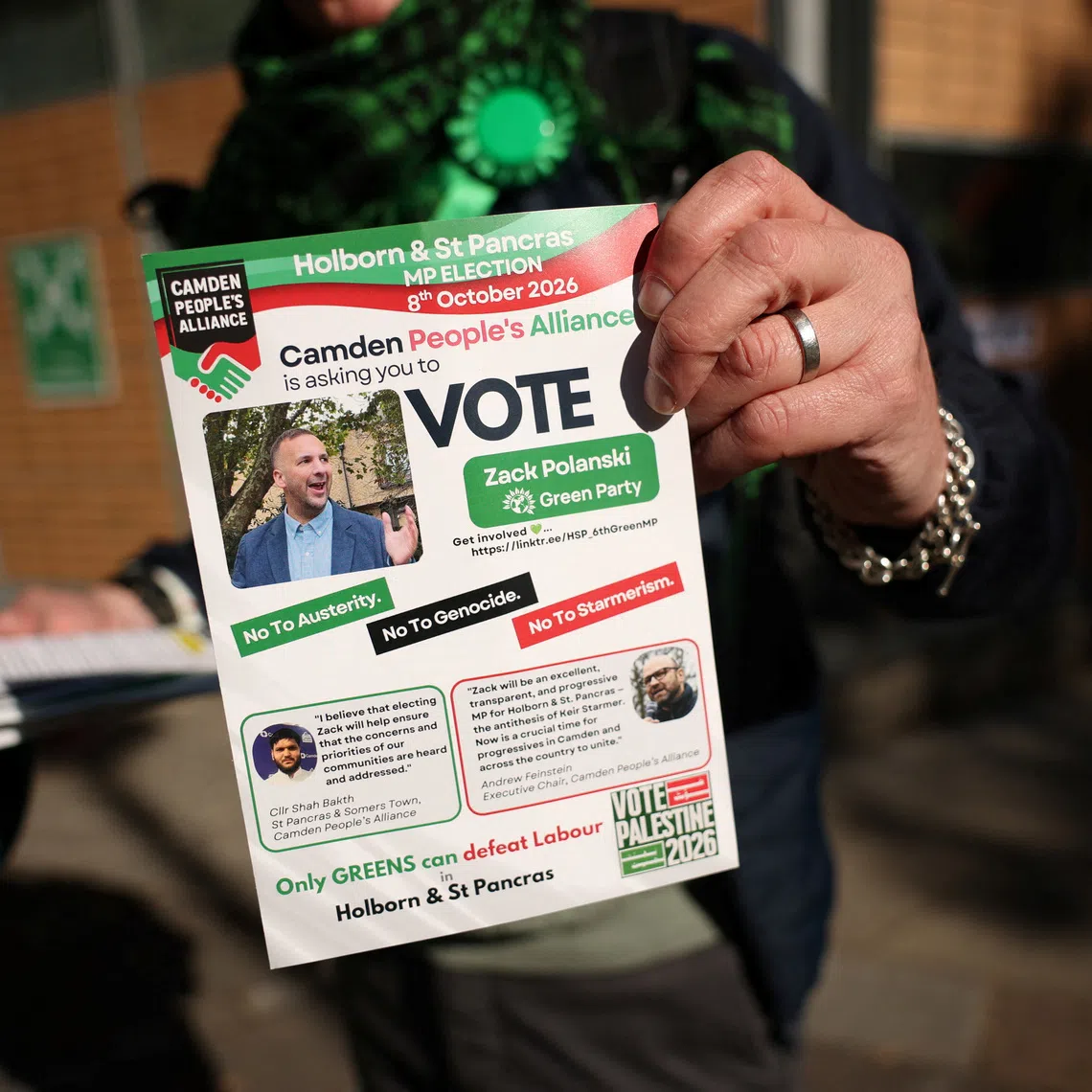 A Green Party supporter shows a flyer calling to vote for Zack Polanski as voters head to the polls in the Holborn and St Pancras by-election, triggered by the resignation of former Prime Minister Keir Starmer as MP for Holborn and St Pancras, in London, Britain, October 8, 2026. REUTERS/Isabel Infantes