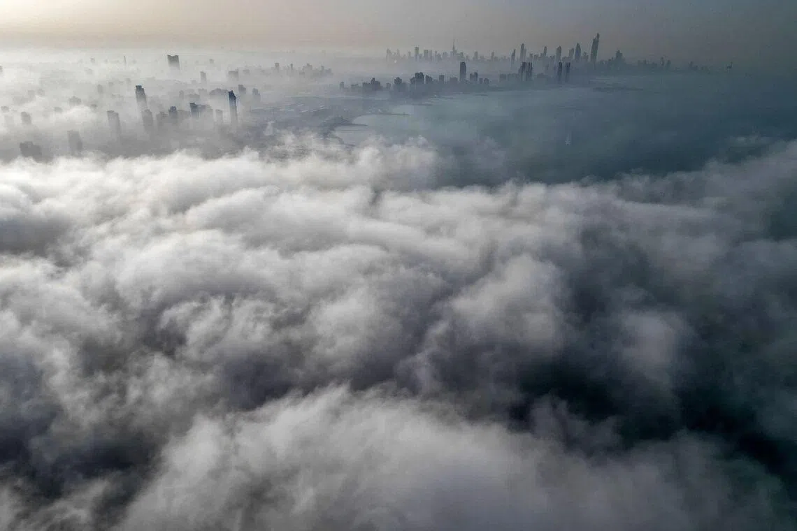 TOPSHOT - Buildings are seen through a veil of fog rolling over al-Salmeyya district in Kuwait City on February 9, 2026. (Photo by Yasser Al-Zayyat / AFP)