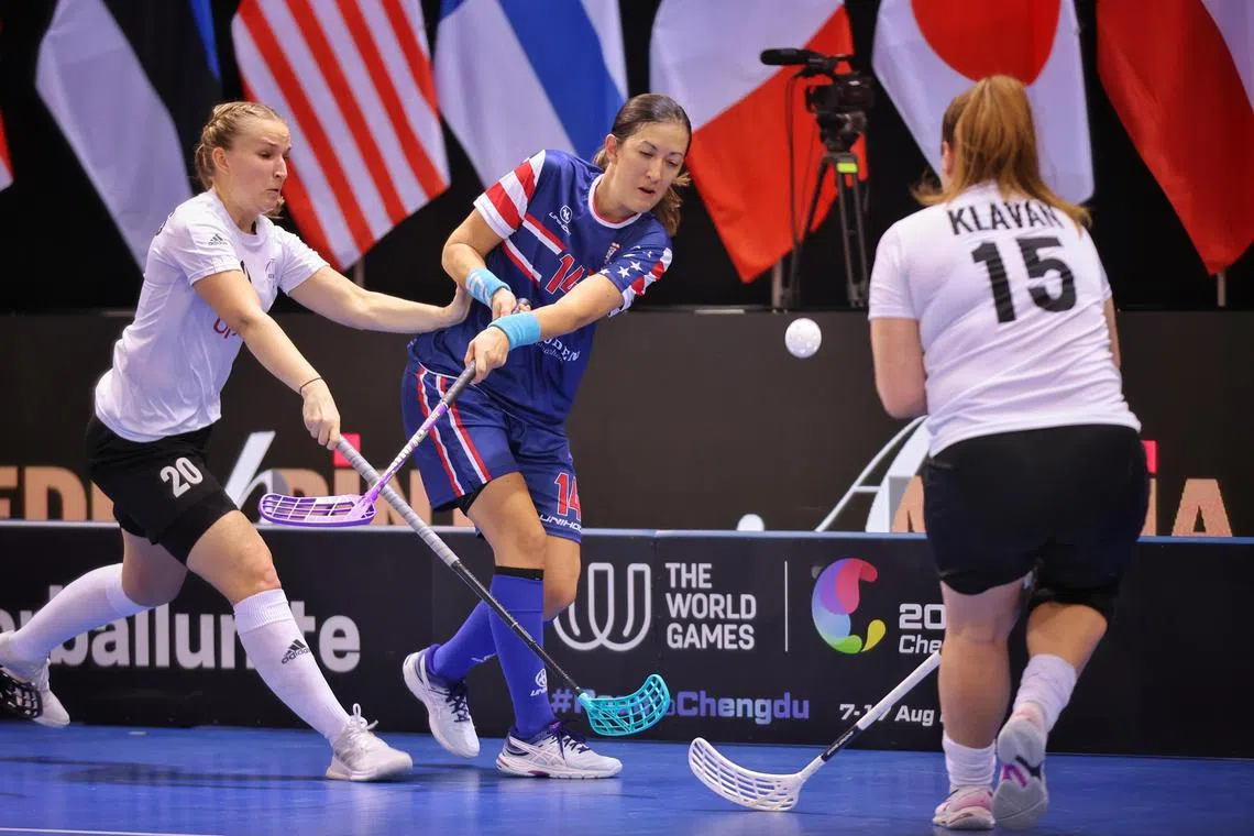 USA’s Tiffany Gerber (blue, 14) competes against Estonia in the Women’s World Floorball Championship at OCBC Arena on Dec 2, 2023.