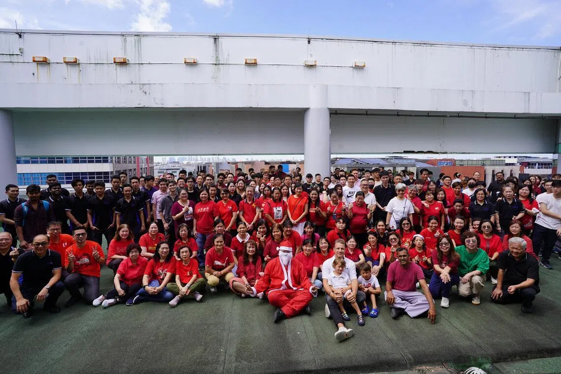 MatSing’s executive vice-president Michael Matytsine (front row, in white) with Singapore staff at the company’s base in Kaki Bukit during a Christmas event.