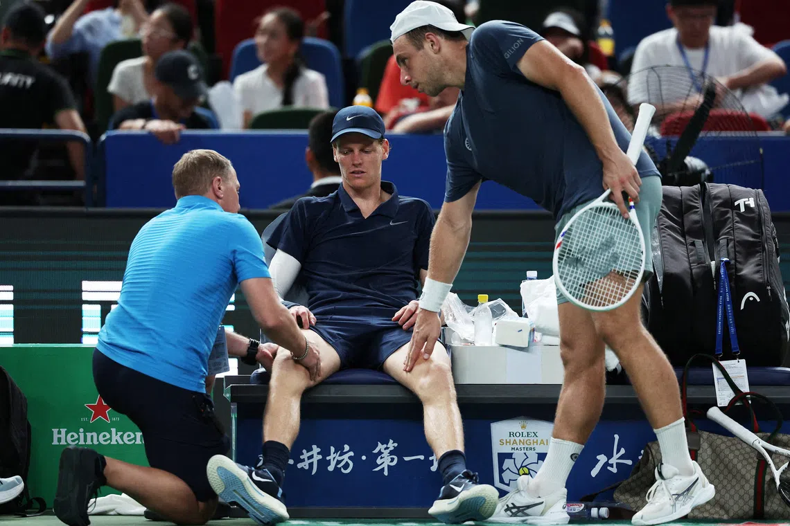 Tennis - ATP Masters 1000 - Shanghai Masters - Qizhong Forest Sports City Arena, Shanghai, China - October 5, 2025 Italy's Jannik Sinner receives medical attention before retiring due to an injury in his round of 32 match against Netherlands' Tallon Griekspoor REUTERS/Go Nakamura