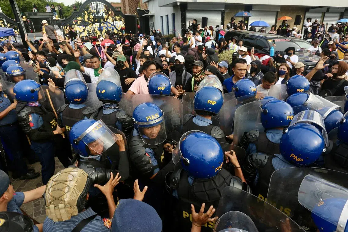 Police block supporters of wanted preacher Apollo Quiboloy outside a 30ha compound in Davao city, in southern Philippines.