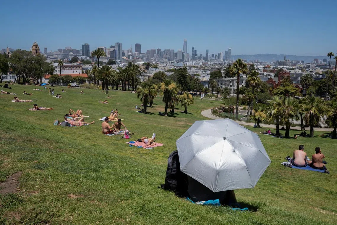 People rest at Dolores Park during a heat wave as temperatures climb to over 80 Fahrenheit (26.7 degrees Celsius), in San Francisco, California, U.S., July 2, 2024. REUTERS/Emily Steinberger