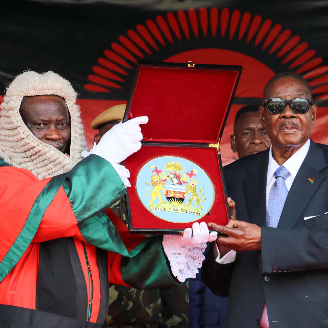 Arthur Peter Mutharika, the newly elected seventh president of Malawi, holds a Bible as he takes oath of office from the Chief Justice of the Malawi Supreme Court, Justice Rezine Mzikamanda shortly after his inauguration at the Kamuzu stadium in Blantyre, Malawi, October 4, 2025.  REUTERS/Eldson Chagara