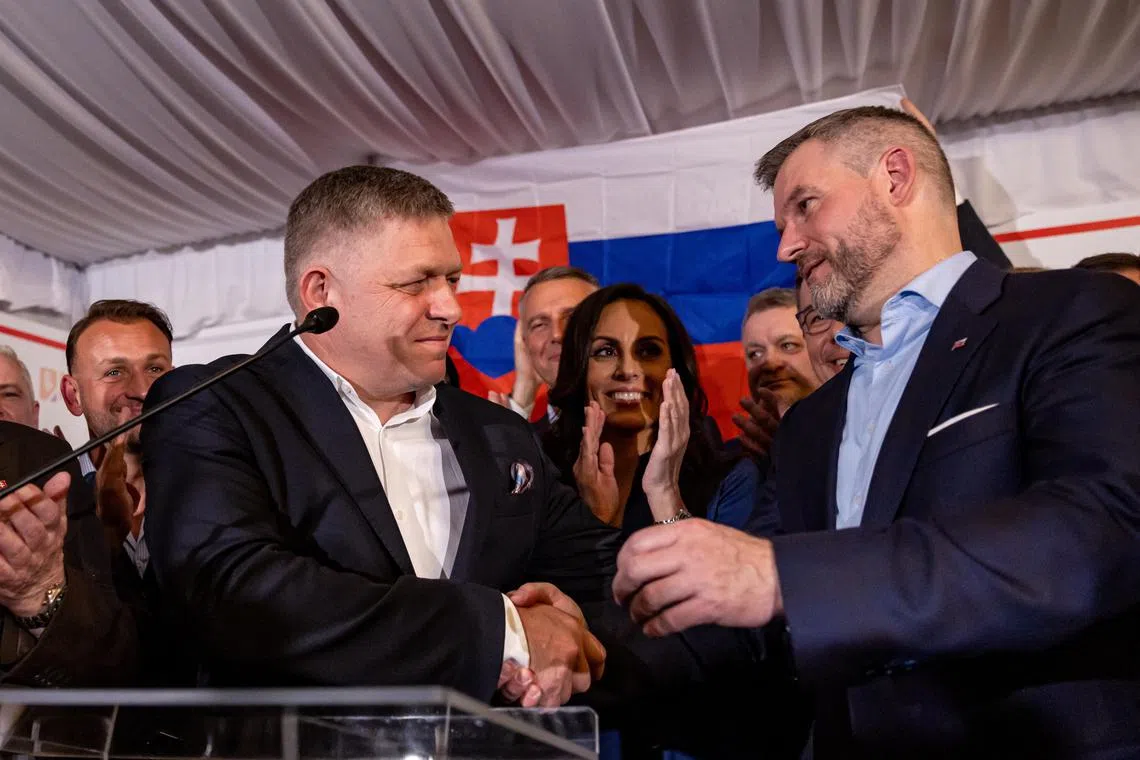 epa11263334 Slovak presidential candidate and speaker of the National Council Peter Pellegrini (R) shakes hands with Slovak Prime Minister Robert Fico (L) on election night during Slovakia's presidential election run-off at his headquartes in Bratislava, Slovakia, 06 April 2024. According to exit polls from more than 99.66 percent of polling stations, Pellegrini has won 53.26 percent of the votes compared to 46.73 percent won by his opponent, former Slovak Foreign Minister Ivan Korcok.  EPA-EFE/MARTIN DIVISEK