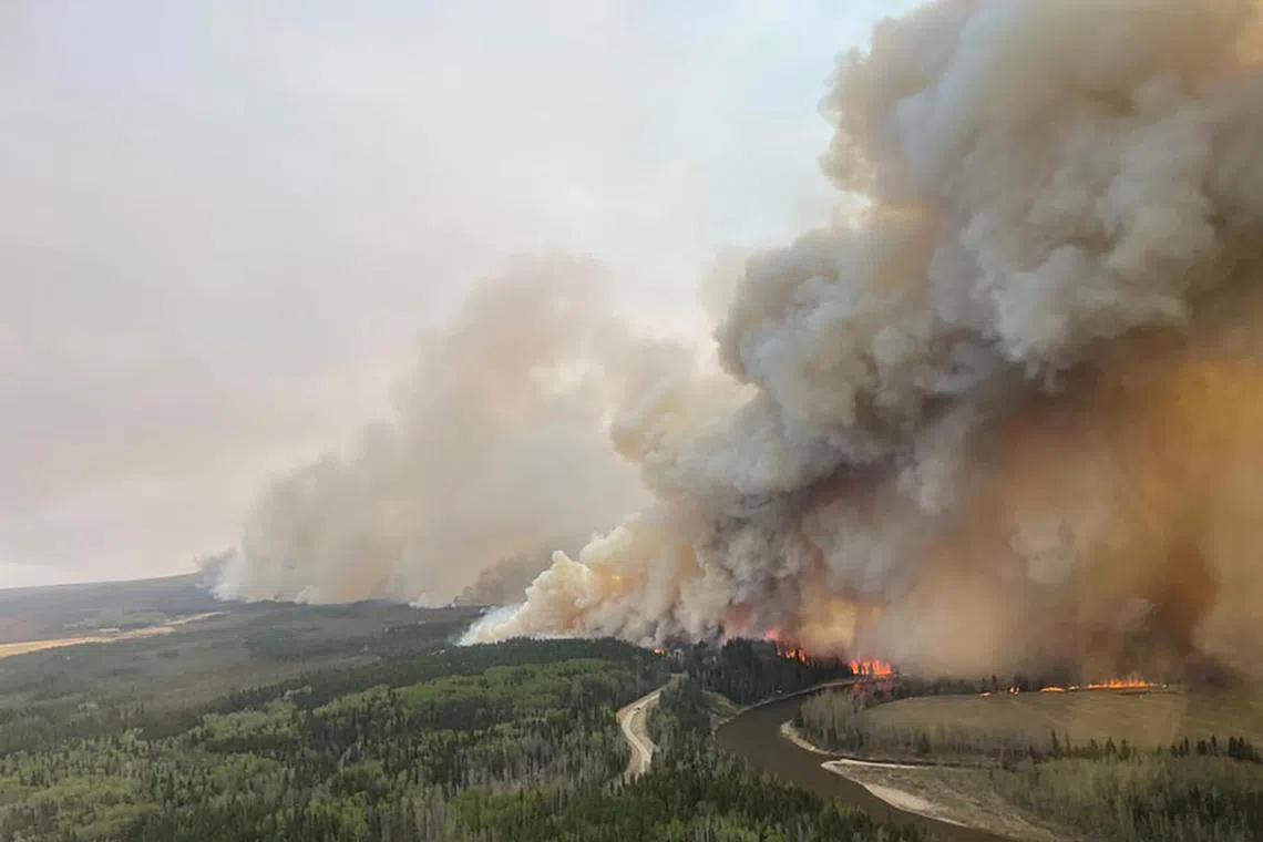 A smoke column rises from wildfire  near Shining Bank, Alberta, Canada on Friday. 