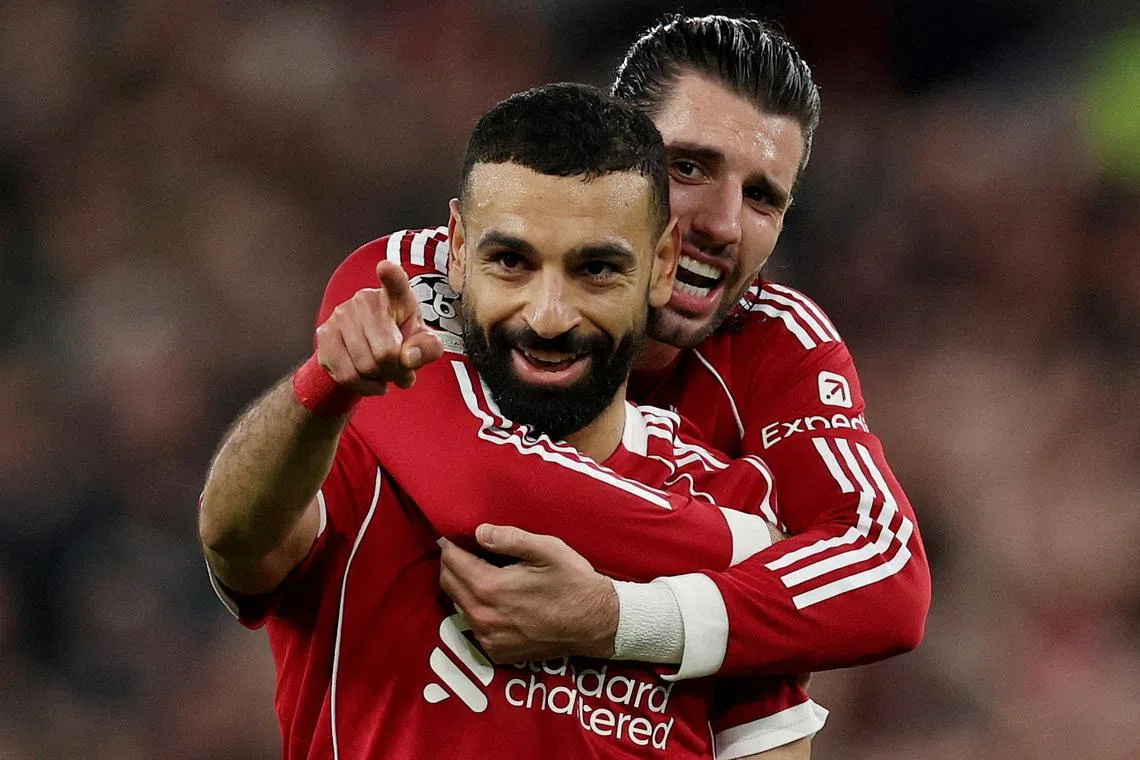Soccer Football - UEFA Champions League - Round 16 - Second Leg - Liverpool v Galatasaray - Anfield, Liverpool, Britain - March 18, 2026 Liverpool's Mohamed Salah celebrates scoring their fourth goal with Dominik Szoboszlai REUTERS/Phil Noble