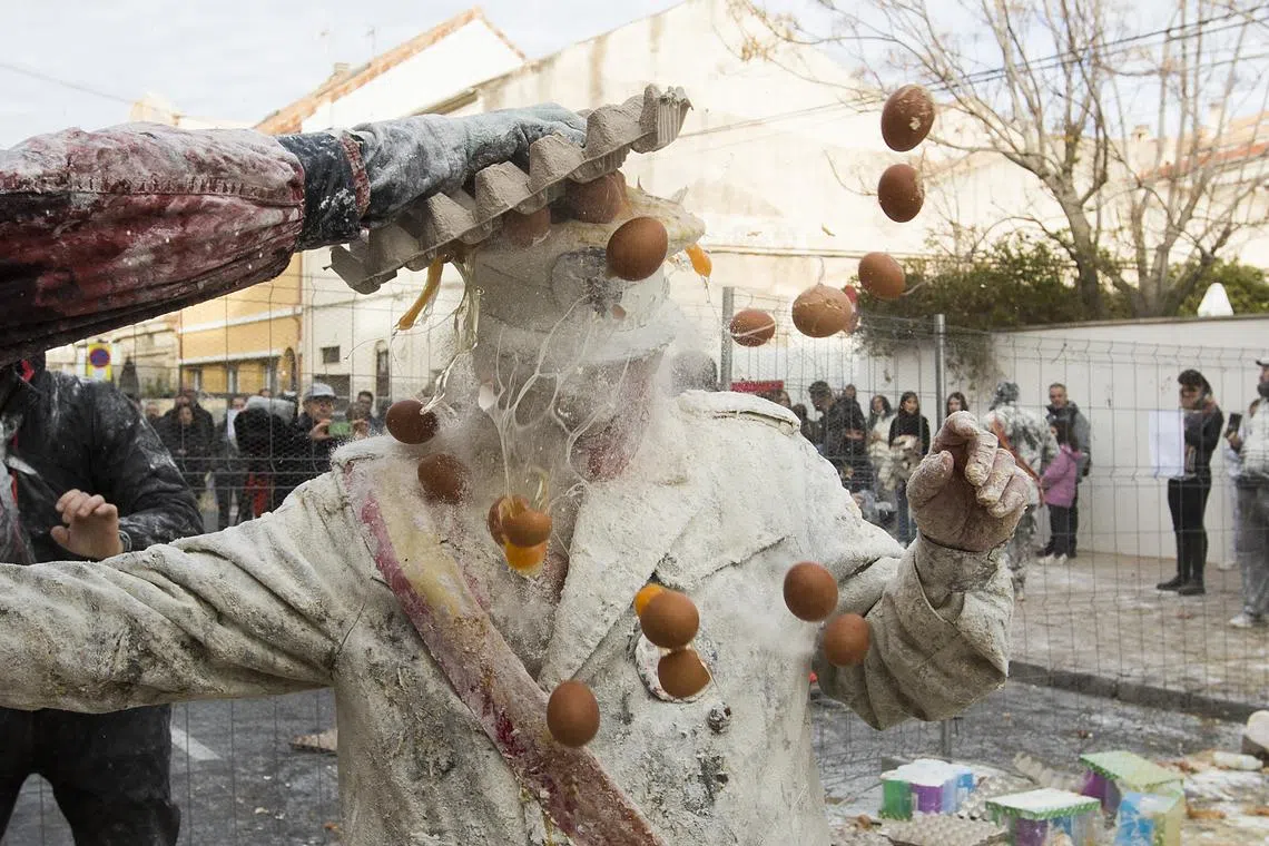 Revellers dressed in mock military garb taking part in the "Els Enfarinats" battle in the southeastern Spanish town of Ibi on Dec 28, 2023. 