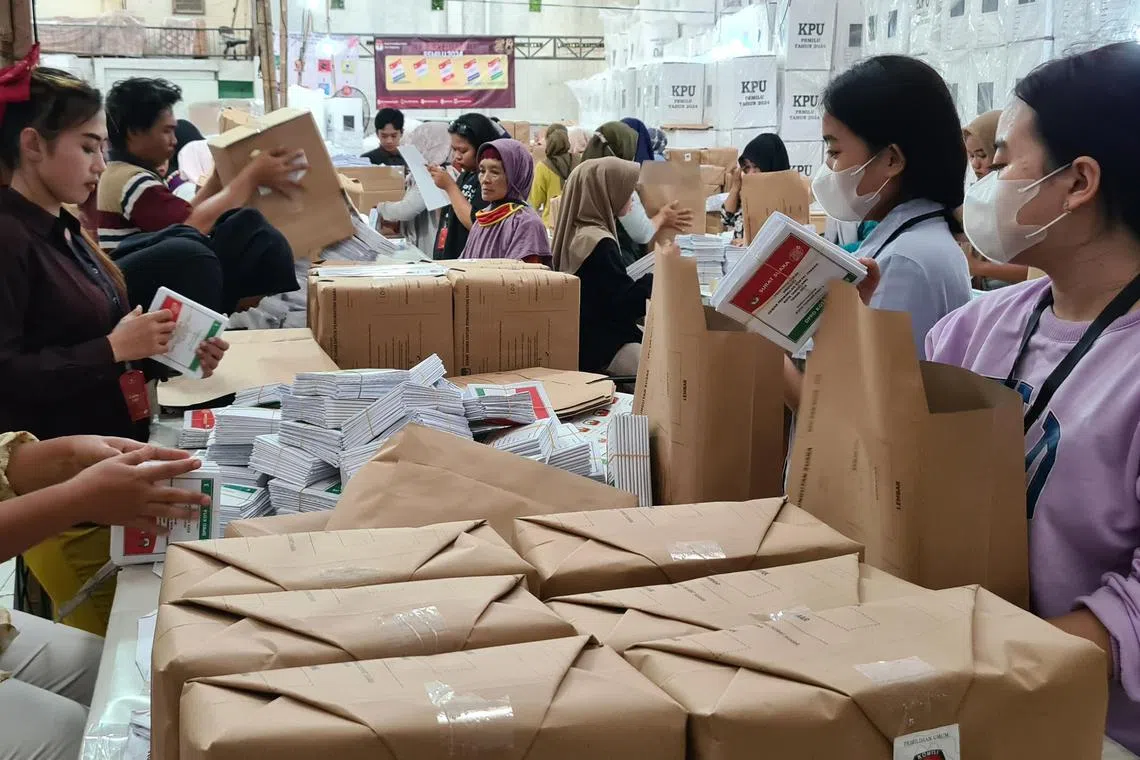Workers packing folded ballot papers at a logistics warehouse of the Indonesian General Elections Commission in the city of Tangerang, Banten.  The ballots would later be distributed to voting stations in Indonesia.

CREDIT: THE STRAITS TIMES/LINDA YULISMAN