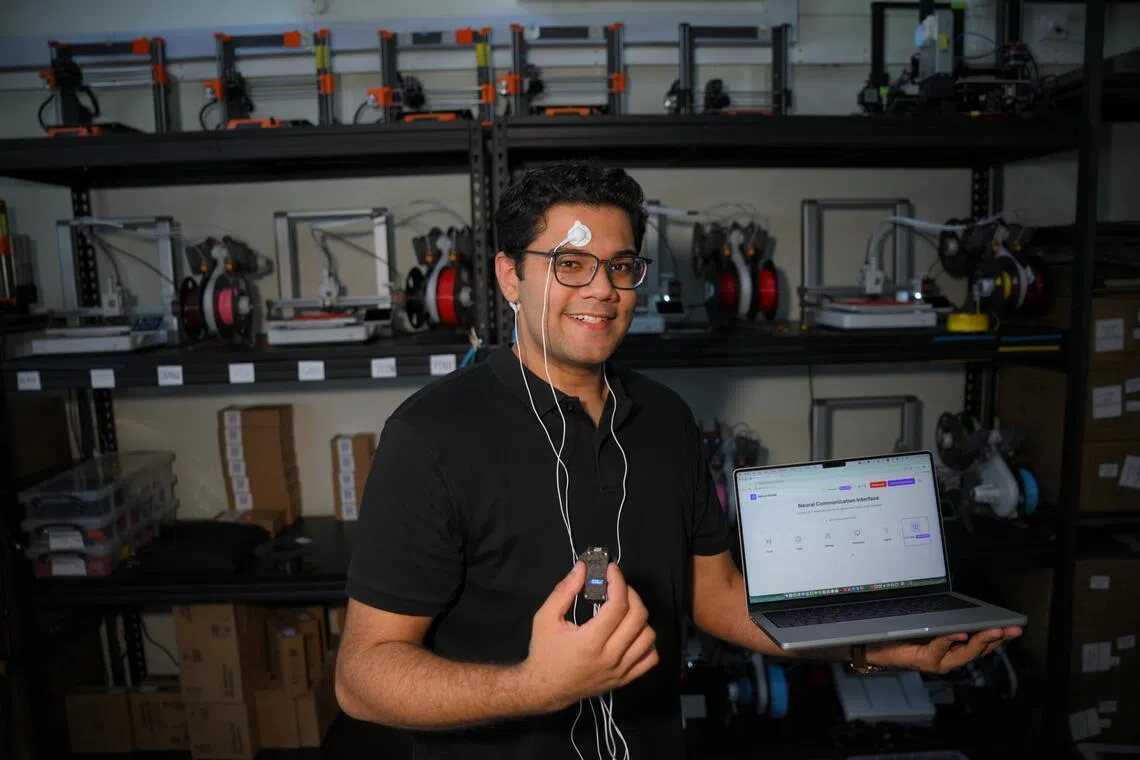 University freshman Khambhati Mohammed Huzefa with his neural device, which allows paralysed patients to communicate via brainwaves and eye blinks.